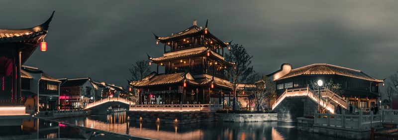 Illuminated building against sky at night