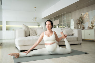 Portrait of woman sitting on sofa at home