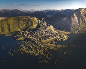 Aerial view of lake and mountains against sky