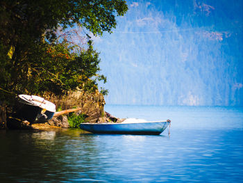 Man on boat in sea against sky