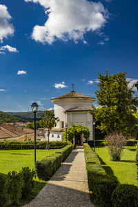 Built structures on field against sky