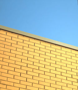 Low angle view of building against clear blue sky