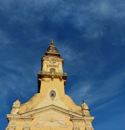 Low angle view of clock tower against sky