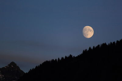 Scenic view of moon against clear sky at night