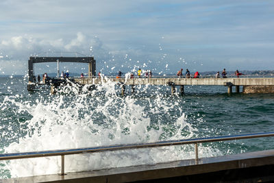 Waves crashing on the pier.  blue sky with clouds in strong sunny day.  ponta do humaitá, salvador 