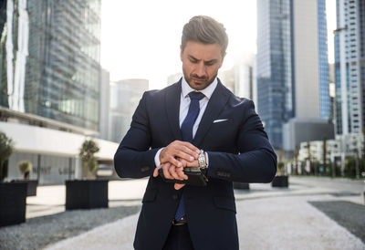 Businessman standing outdoors in city