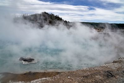 Steam rising over yellowstone geyser