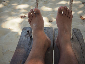 Low section of person relaxing on beach