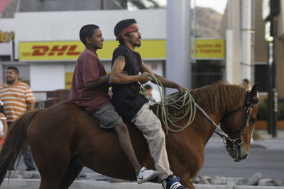 Full length of man riding horse