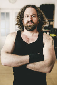 Portrait of angry man standing indoors