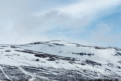 Scenic view of snow covered mountain against sky