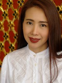 Portrait of smiling mature woman wearing red lipstick