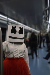 Woman wearing mask in subway train