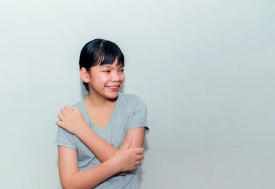 Portrait of smiling girl against white background