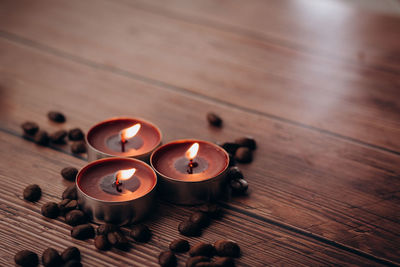 High angle view of illuminated candles on table