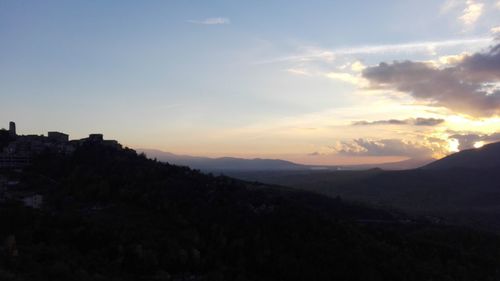 Scenic view of silhouette mountains against sky at sunset