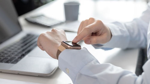 Midsection of doctor holding dentures