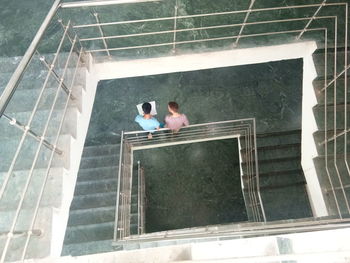 High angle view of men walking on staircase