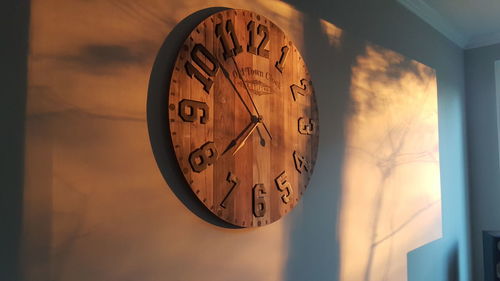 Low angle view of clock against sky during sunset