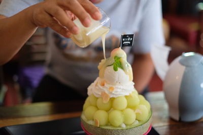 Close-up of hand holding ice cream