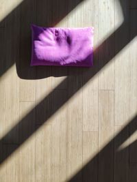 Purple cushion on hardwood floor