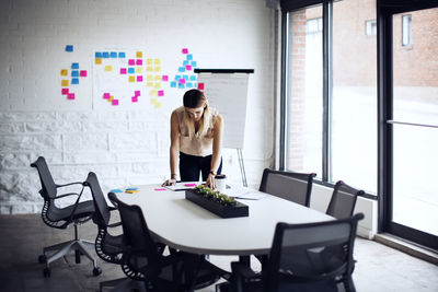 Serious businesswoman working at table in creative office