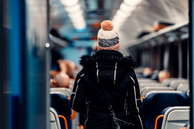 Rear view of man and woman in bus