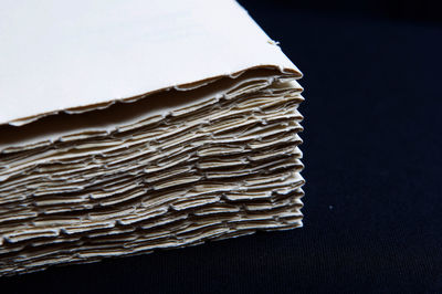 Close-up of stack on table against black background