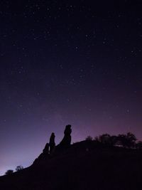 Silhouette mountain against sky at night