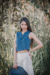 Portrait of smiling young woman sitting on grass