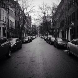 Cars parked on road in city