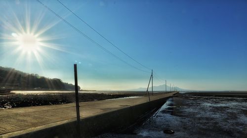 Scenic view of street against bright sun