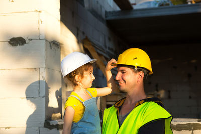 Father with daughter at construction site