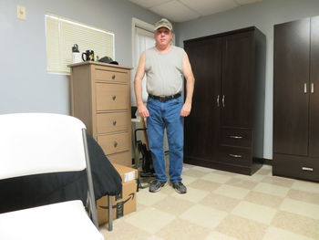 Portrait of smiling man standing at home