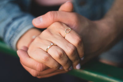 Cropped image of couple holding hands