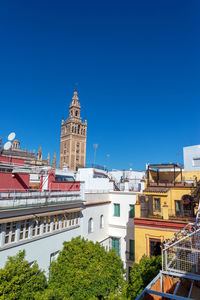 Low angle view of buildings against blue sky