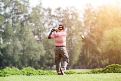 Rear view of man playing golf