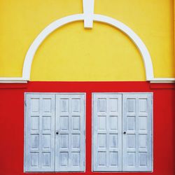 Close-up of yellow door of building