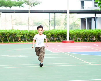 Boy running at basketball court