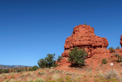 Rock formations against clear blue sky