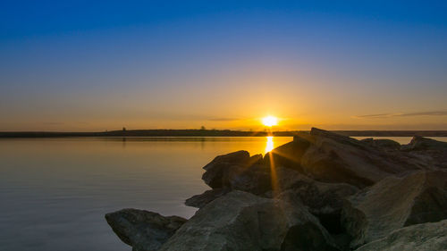 Scenic view of lake at sunset