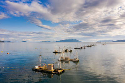 Boats moored in sea against sky