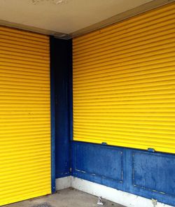 Yellow closed shutters of shop
