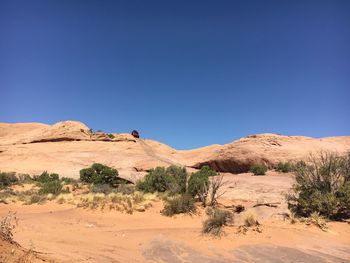 Scenic view of desert against clear blue sky