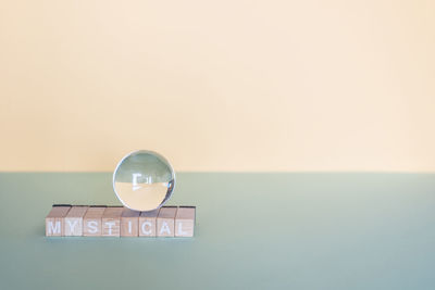 Close-up of illuminated lighting equipment on table against wall