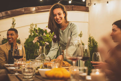 Portrait of young woman sitting at restaurant