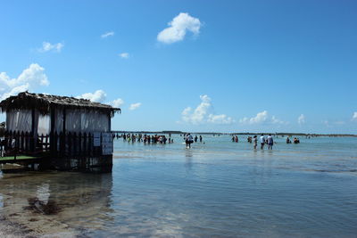 People on beach against sky