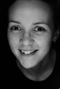 Close-up portrait of smiling young woman