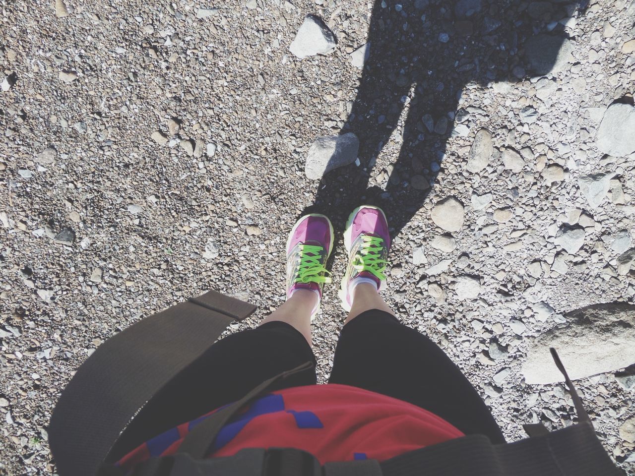 low section, person, shoe, high angle view, lifestyles, personal perspective, standing, leisure activity, street, human foot, footwear, men, directly above, day, shadow, outdoors