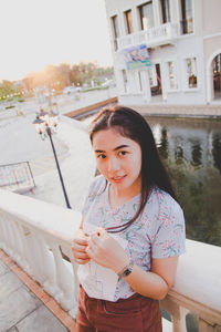 Portrait of woman standing in city